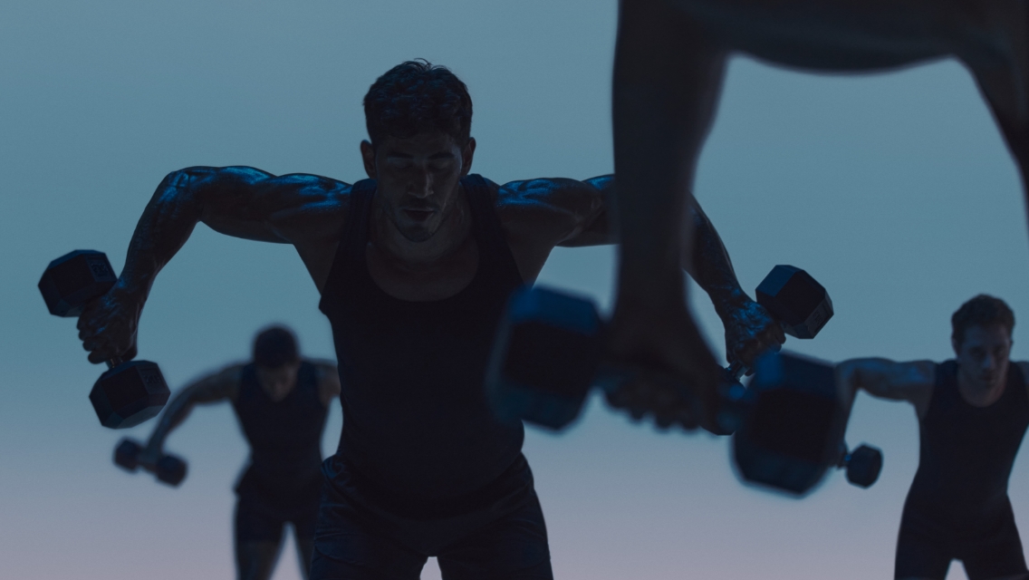 Maxout strength class featuring a group of people working out with barbells