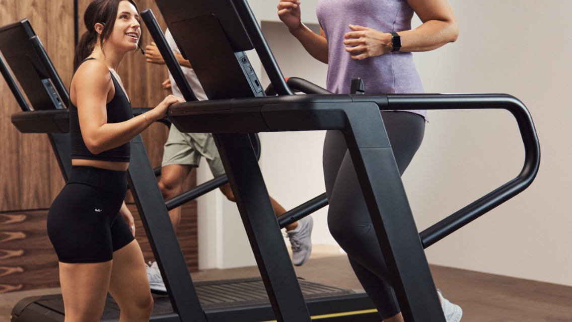 GTX instructor encouraging class member on treadmill