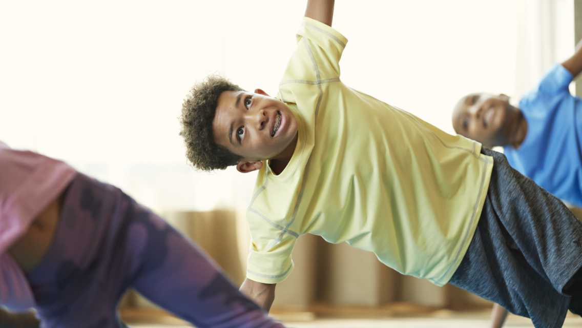 a group of kids in a yoga class
